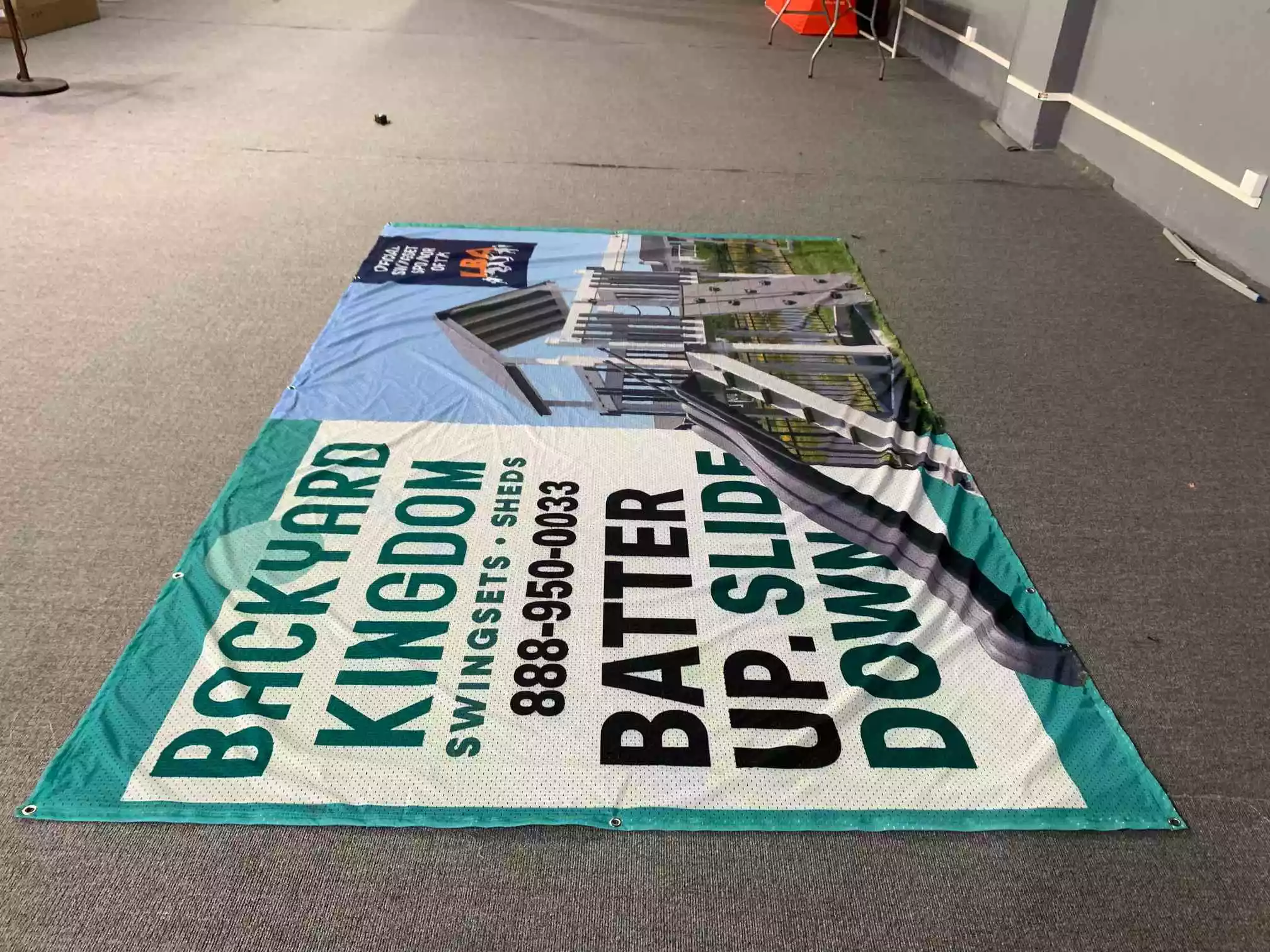 Backyard Kingdom LBA sponsor banner with playset photo